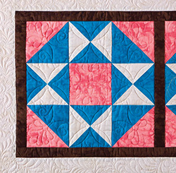 Using simple geometric and symmetrical motifs emphasizes the piecing of a quilt block. 